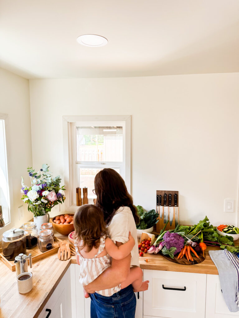 Mother holding and feeding child berries